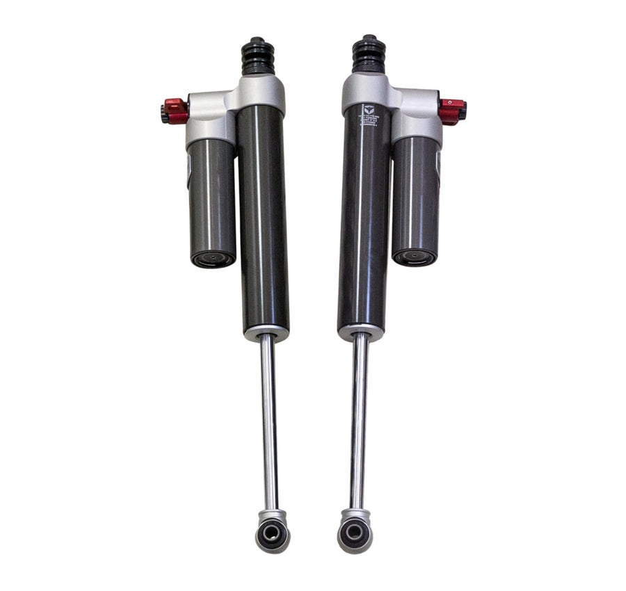 Falcon Shocks by ReadyLIFT: Two Falcon 3.3 shocks with piggyback reservoirs and red adjuster knobs on white.