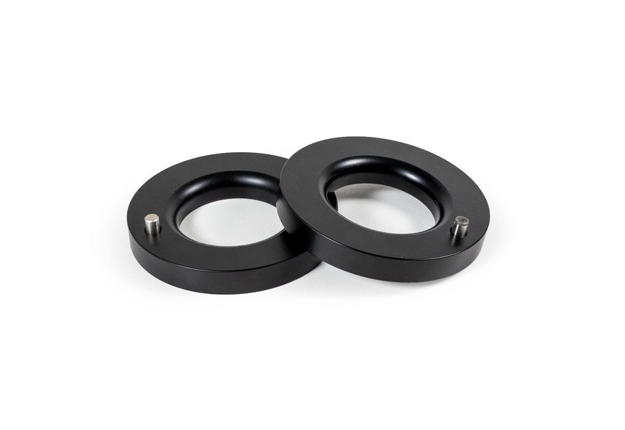 Leveling Kits by ReadyLIFT: Pair of thin black pre-load spacer rings with locating pins on white.