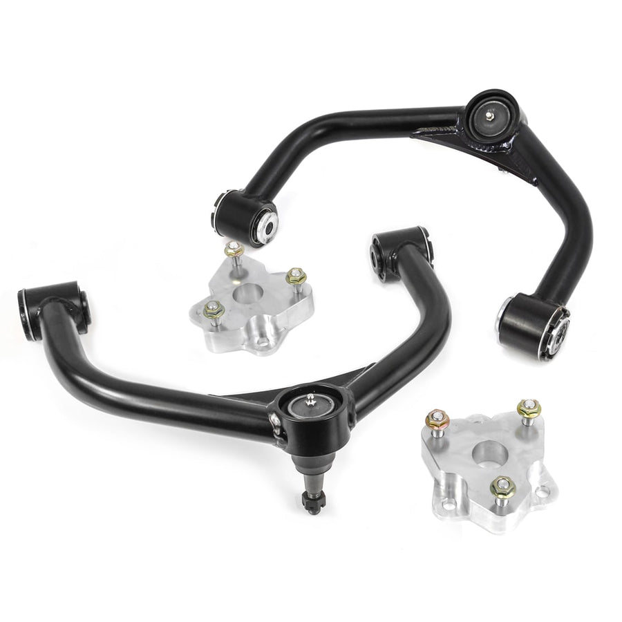 Leveling Kits by ReadyLIFT: Two black tubular upper control arms and two aluminum strut spacers on white.