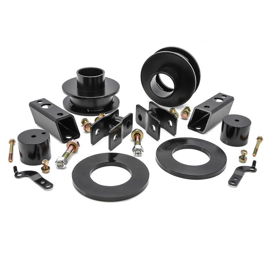 Leveling Kits by ReadyLIFT: Black coil spacers, rings, bump stop spacers, shock extensions and bolts on white.