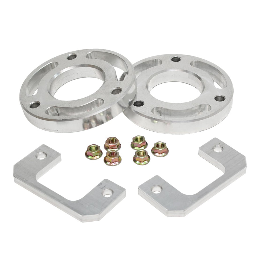 Leveling Kits by ReadyLIFT: Two aluminum spacer rings with nuts and two aluminum brackets on white.