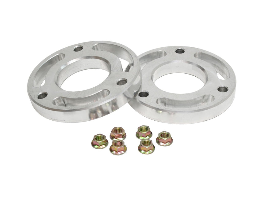 Leveling Kits by ReadyLIFT: Two machined aluminum spacer rings with eight flange nuts on white.