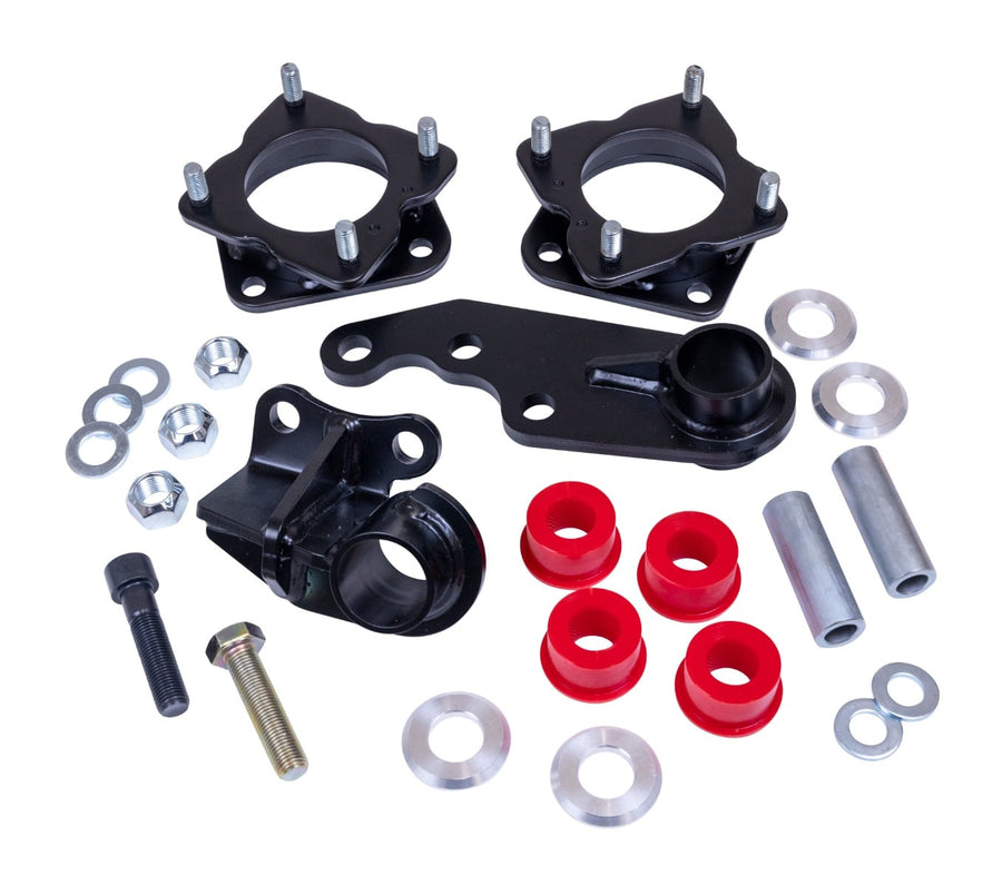 Leveling Kits by ReadyLIFT: Two black strut spacers with diff drop brackets, red bushings, sleeves, washers and bolts on white.