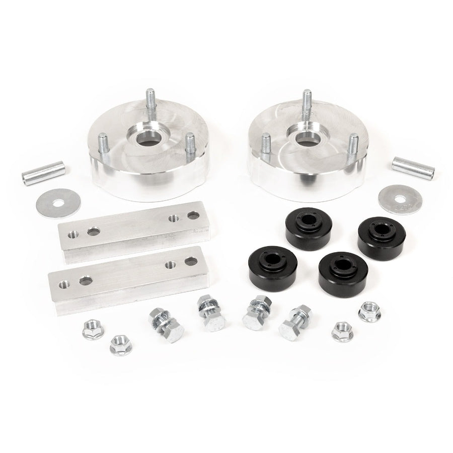 Leveling Kits by ReadyLIFT: Two aluminum strut spacers with studs, two aluminum blocks, black bushings and hardware on white.