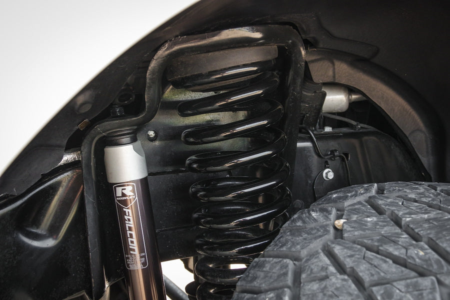 MAX Suspension Systems by ReadyLIFT: Black coil spring and Falcon shock with ReadyLIFT R badge installed in a front wheel well.