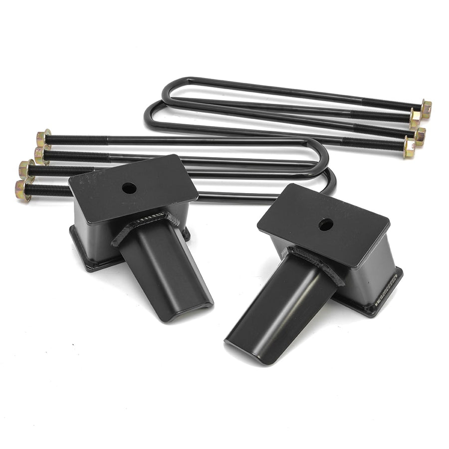 Rear Block Kits by ReadyLIFT: Two tall black fabricated tapered rear lift blocks with long square U-bolts and nuts on white.