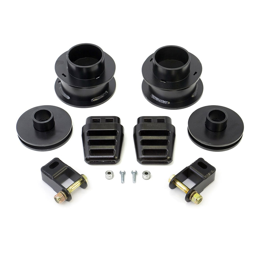 SST Lift Kits by ReadyLIFT: Front and rear black coil spacers, bump stop extensions, two brackets and hardware on white.