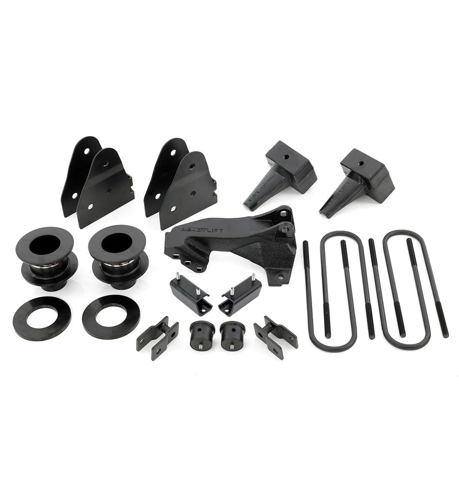 SST Lift Kits by ReadyLIFT: Coil spacers, track bar bracket, shock brackets, tapered rear blocks and U-bolts on white.