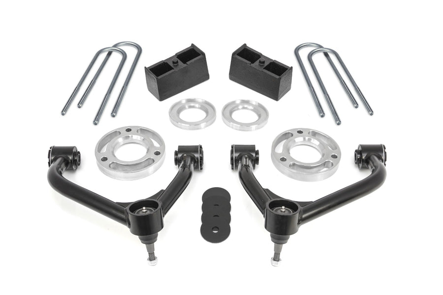 SST Lift Kits by ReadyLIFT: Two black upper control arms, aluminum strut spacers, rear blocks, zinc U-bolts and bump stop pads on white.