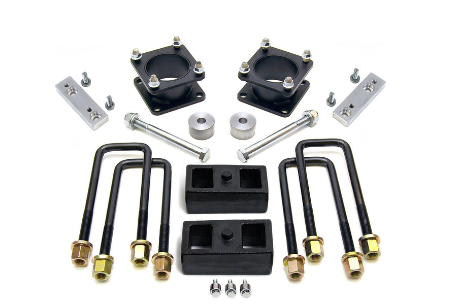 SST Lift Kits by ReadyLIFT: Two black square strut spacers, aluminum brackets, two rear blocks, U-bolts and bolts on white.