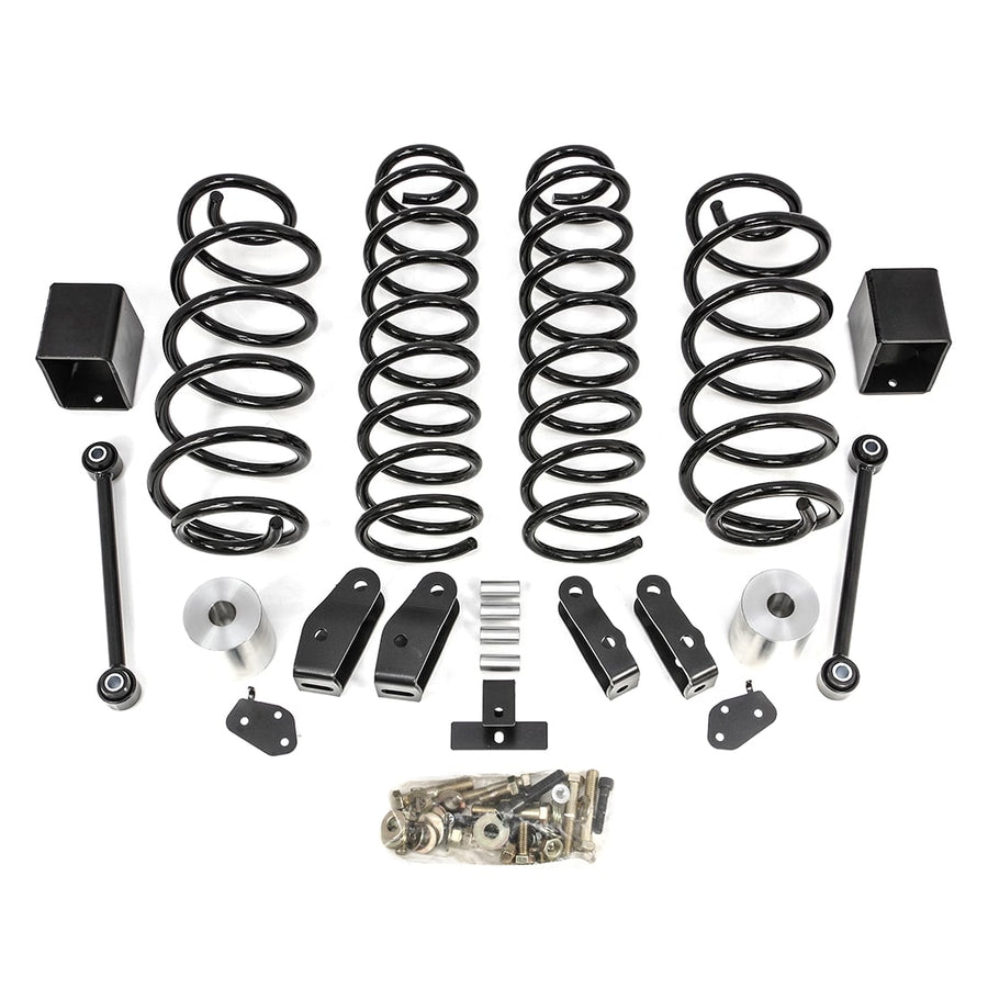SST Lift Kits by ReadyLIFT: Four black coil springs, aluminum bump stop spacers, brackets, links and a hardware bag on white.