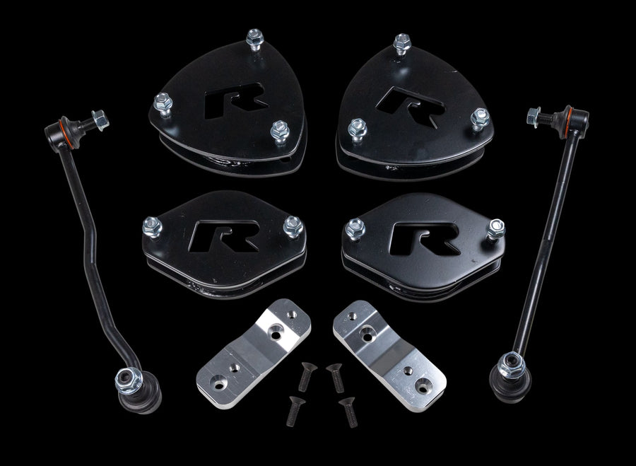 SST Lift Kits by ReadyLIFT: Four black R strut spacers, two sway bar links, two aluminum brackets and bolts on a black background.
