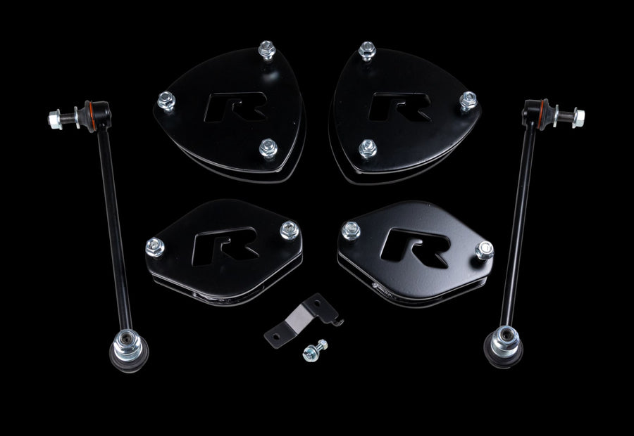 SST Lift Kits by ReadyLIFT: Four black R strut spacers, two sway bar links and a small bracket on a black background.