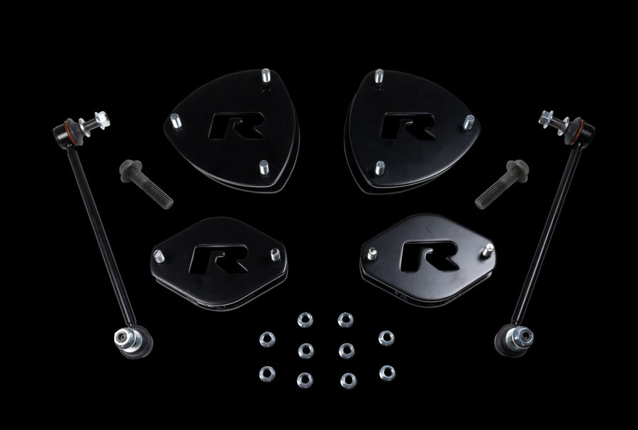 SST Lift Kits by ReadyLIFT: Four black R strut spacers, two sway bar links, bolts and nuts on a black background.