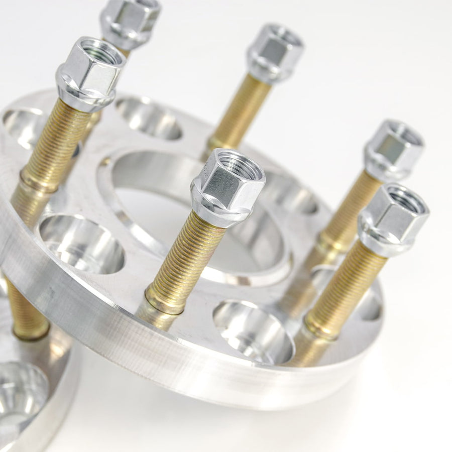 Wheel Spacers by ReadyLIFT: Close-up of a machined aluminum wheel spacer with gold studs and lug nuts.