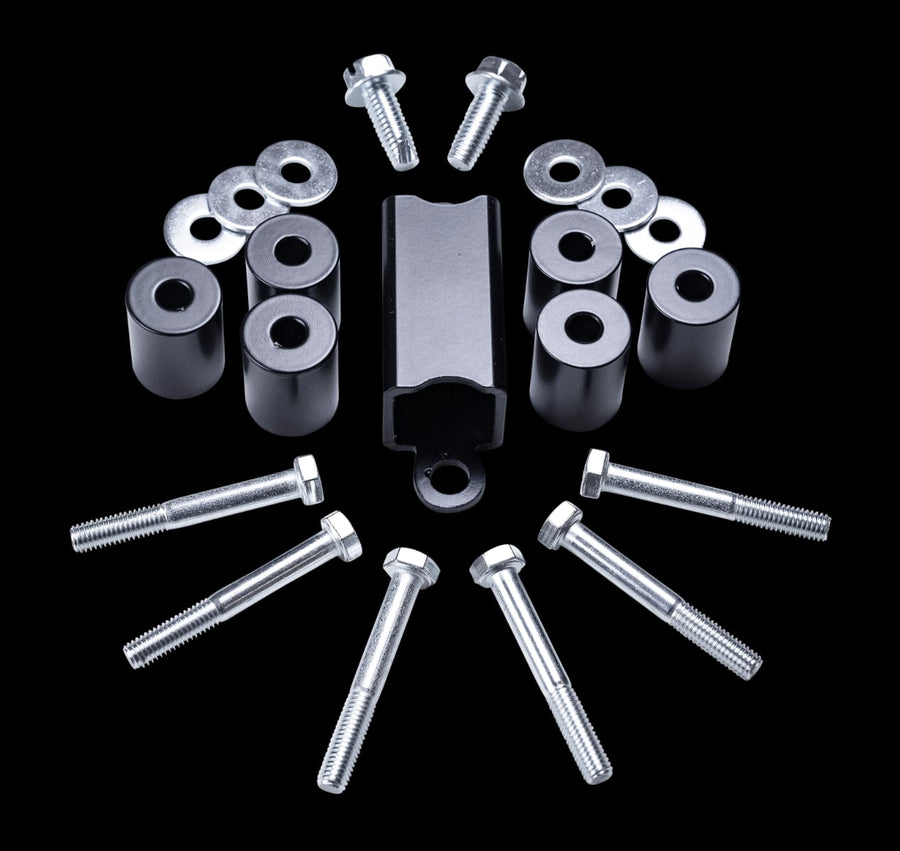 Skid Plates & Protection by ReadyLIFT: Black cylindrical spacers, a black bracket, long bolts and washers on a black background.