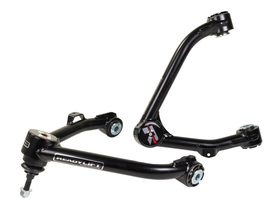 Upper Control Arms by ReadyLIFT: Two black ReadyLIFT tubular upper control arms with red R caps stacked on white.