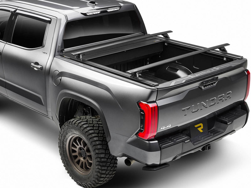 Retrax EQ cover partly open with crossbars mounted on the Trax rails (crossbars sold separately)