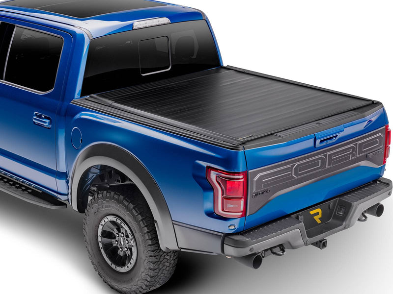 Retrax IX retractable cover fully closed on a blue pickup, studio rear three-quarter view