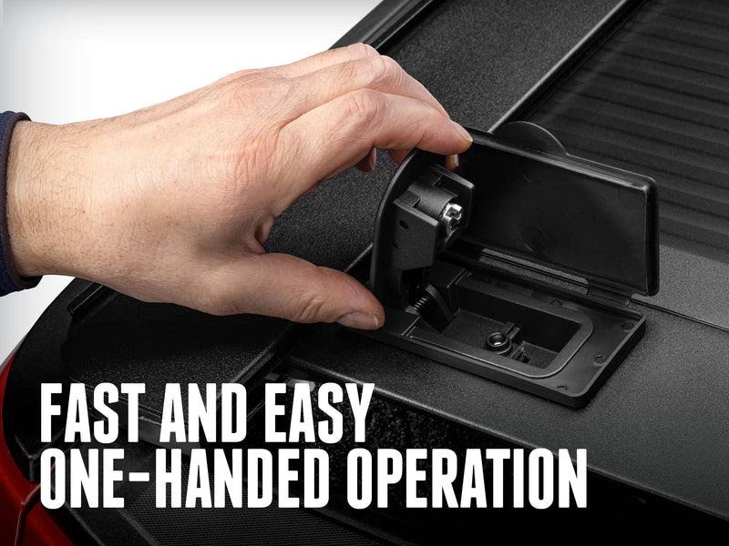 A man's hand lifting the RetraxONE XR spring-loaded handle out of its lid on the end slat, overlay headline about one-handed operation