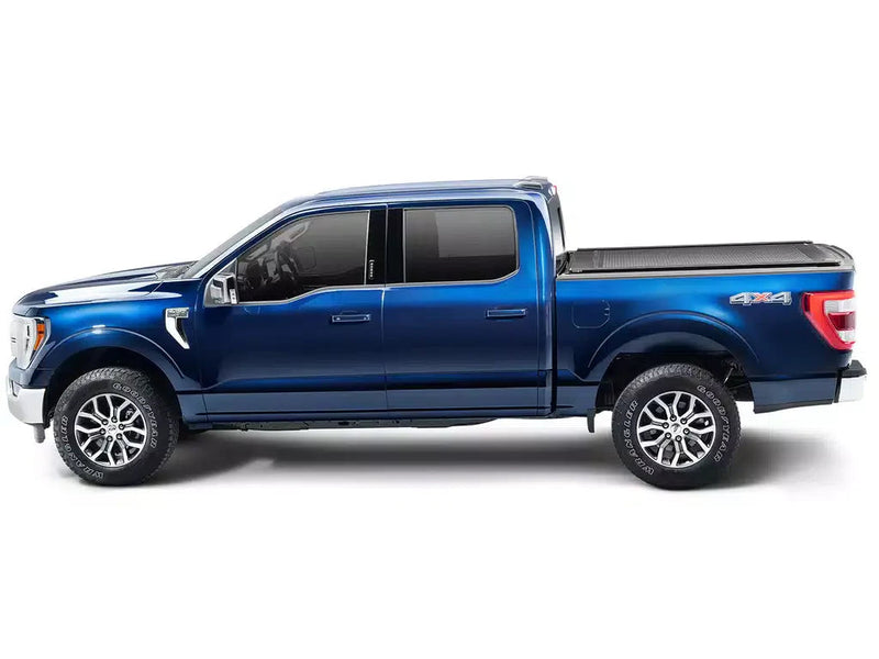 Side profile of a blue pickup with the RetraxONE XR closed flush with the bed rails