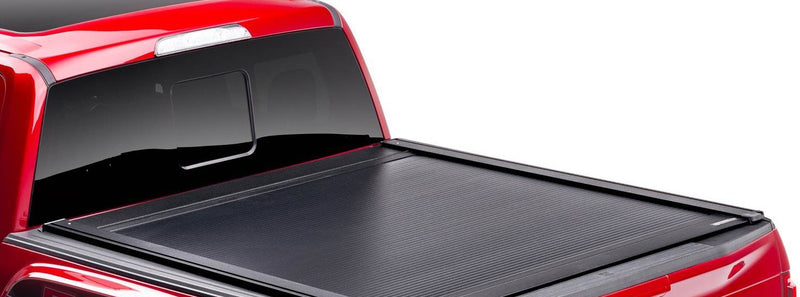 PowertraxONE XR retractable cover fully closed on a red pickup, rear three-quarter view
