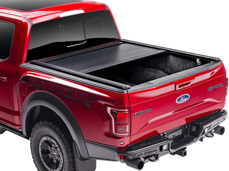 PowertraxONE XR stopped about half open on a red pickup, rear three-quarter view