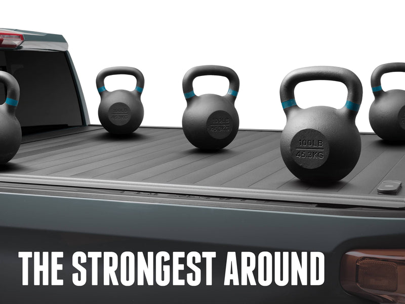 Closed PRO MX slat deck carrying five 100 lb kettlebells, THE STRONGEST AROUND caption