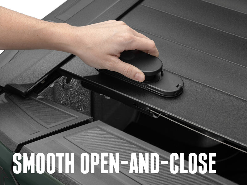 Hand gripping the oval TraxLatch handle on the PRO MX lead slat, SMOOTH OPEN-AND-CLOSE caption