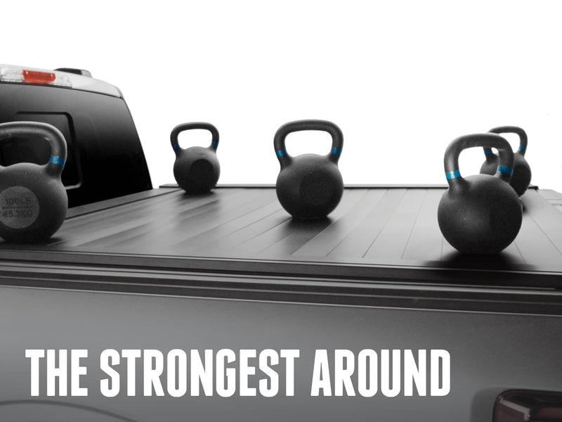 Kettlebells resting on the closed slatted cover, overlay The Strongest Around