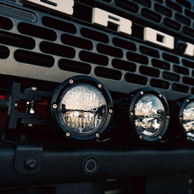 Rigid 360 Connect 30" Light Bar Assembly installed on a Ford Bronco: close-up of round Rigid 360-Series pods on a bumper-mounted bar below a Ford Bronco grille with BRONCO lettering