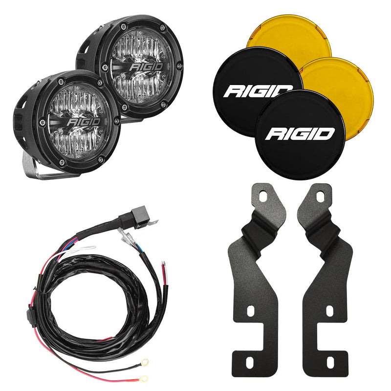 Rigid 360-Series 4" Drive A-Pillar Light Kit, kit contents laid out: pair of black 4" round 360-Series pods with clear lenses, black and amber covers, a wiring harness and two A-pillar brackets on white