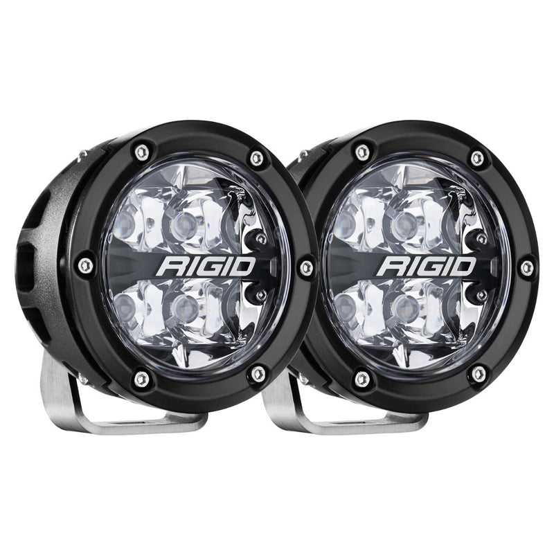 Rigid 360-Series PRO 4" Pair on a studio background: A pair of black 4" round LED lights with clear spot optics on polished brackets, angled against white