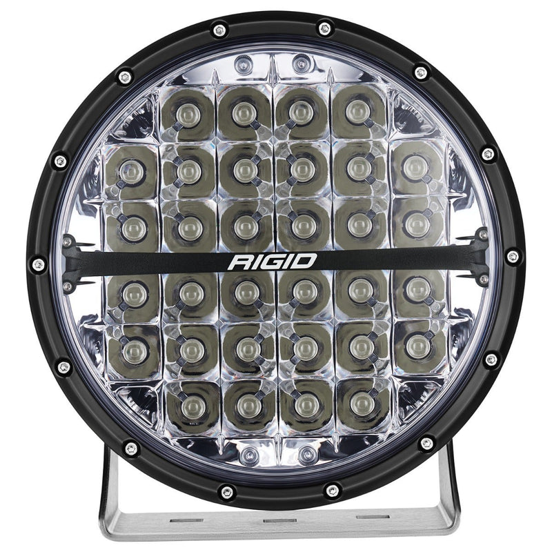 Rigid 360-Series PRO 9" on a studio background: A black 9" round LED light with clear spot optics and polished bracket, front on against white