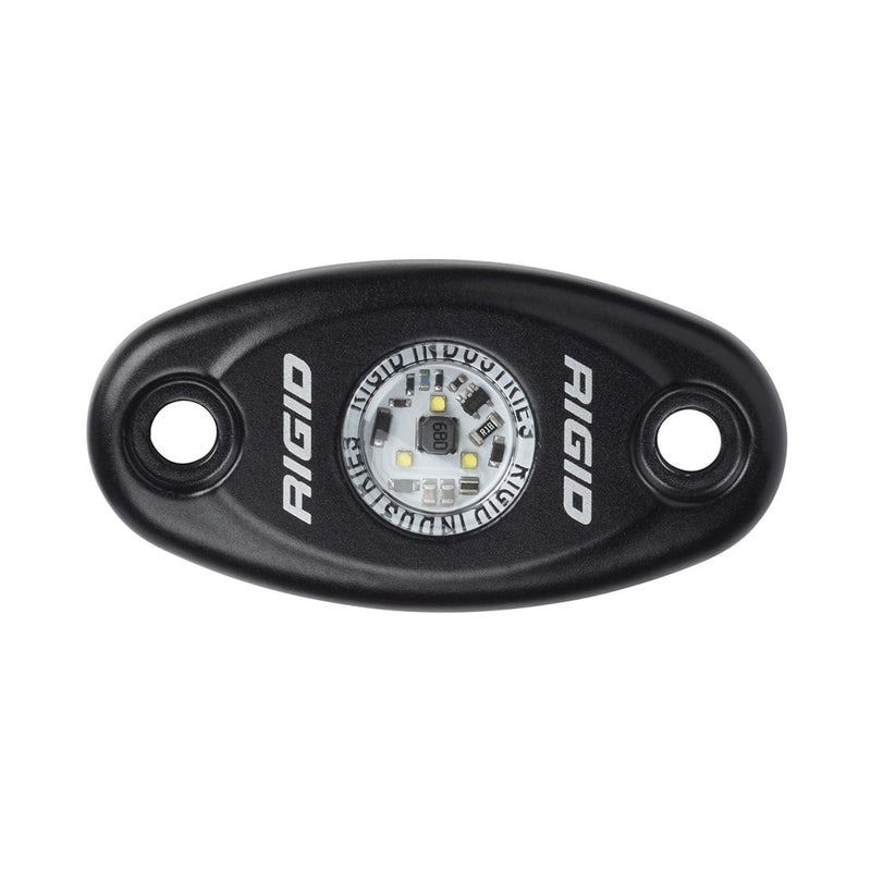 Rigid A-Series Low Power on a studio background: black oval rock light with open screw holes and a single LED in the center, top view on white