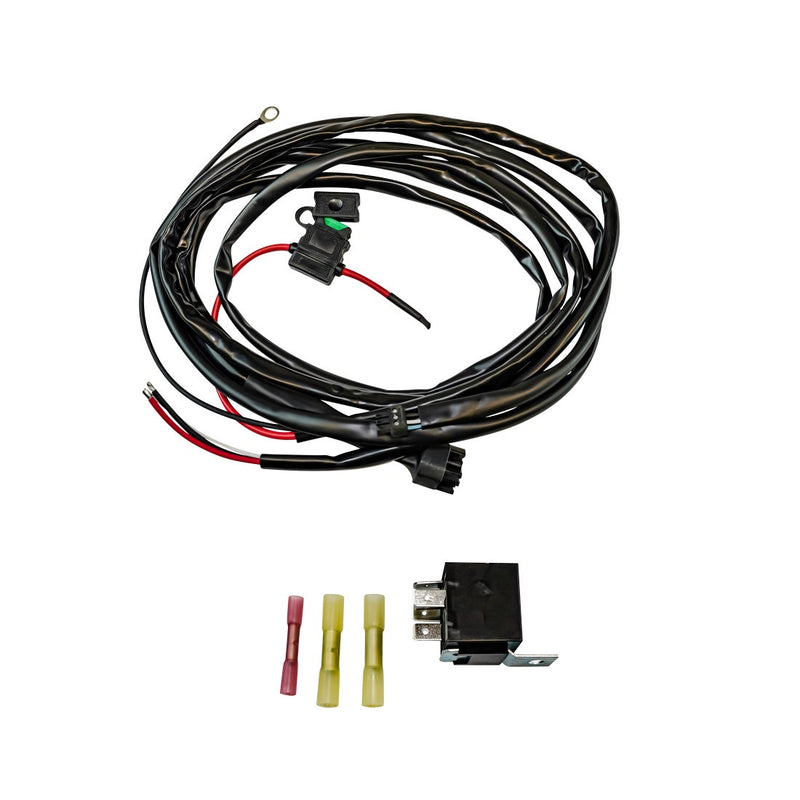 Rigid Adapt Light Bar Small Wire Harness, kit contents laid out: coiled black light bar wire harness with inline fuse holder, shown with a relay and red and yellow butt connectors