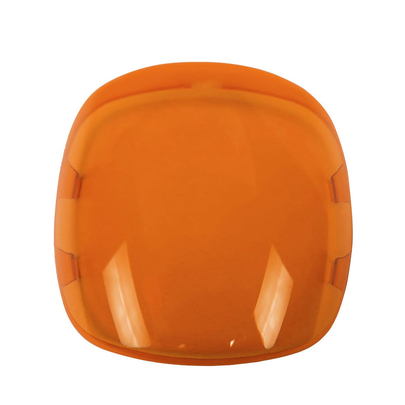 Rigid Adapt XE Cover on a studio background: translucent amber snap-on lens cover with a rounded square shape on white
