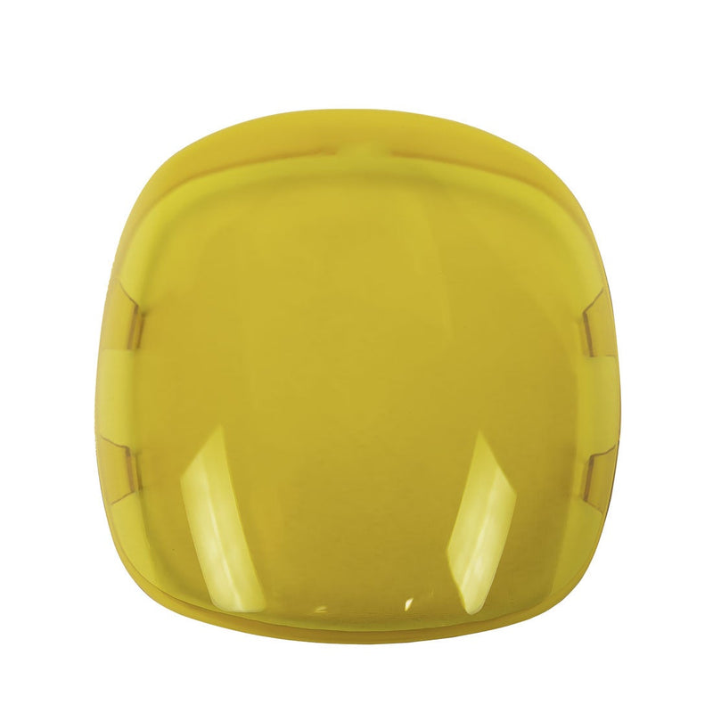 Rigid Adapt XE Cover on a studio background: translucent yellow snap-on lens cover with a rounded square shape on white