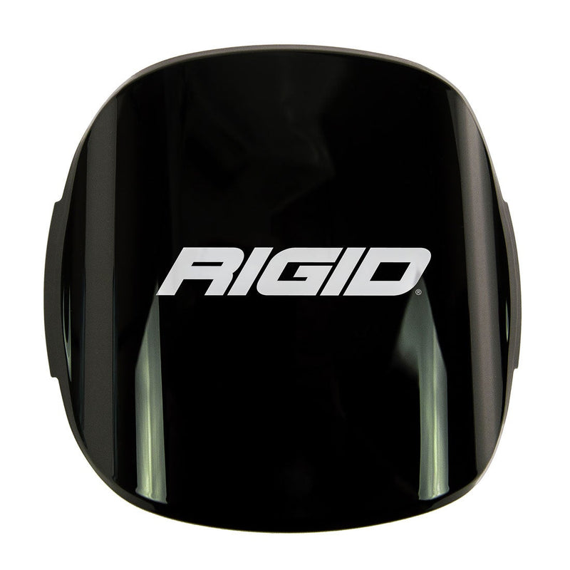 Rigid Adapt XP Cover on a studio background: black snap-on lens cover printed with the Rigid logo on white