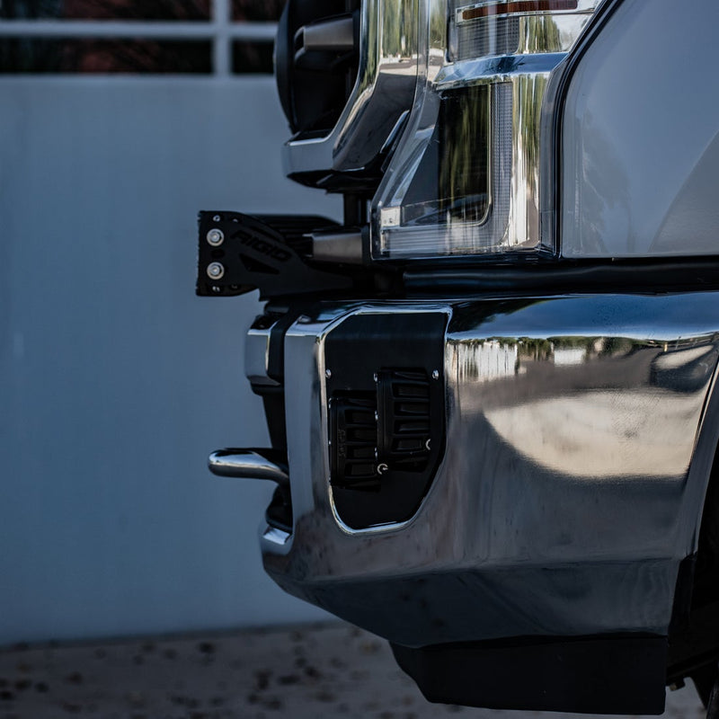 Close-up of the Rigid Bumper Bar Mount: close view of a black bar mount bracket fitted behind the corner of a chrome front bumper