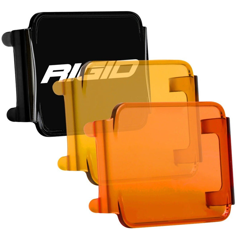 Rigid D-Series Cover, kit contents laid out: black, yellow and amber D-Series lens covers fanned out together on a white background