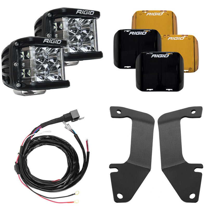 Rigid D-SS Flood A-Pillar Light Kit, kit contents laid out: two Rigid D-SS pods with amber and black covers, a harness and two A-pillar brackets are laid out on white