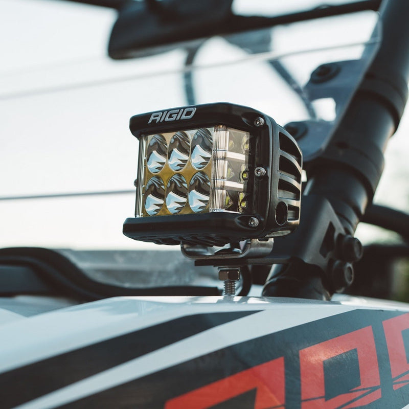 Rigid D-SS PRO Pods Pair installed on a vehicle: A black D-SS PRO pod mounted on the hood of a graphics-wrapped race vehicle in front of its cage
