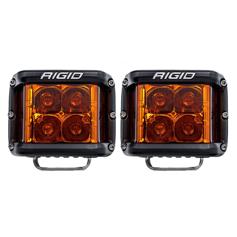 Rigid D-SS PRO Pods Pair on a studio background: A front view of a pair of black D-SS PRO pods with amber lenses on a white background