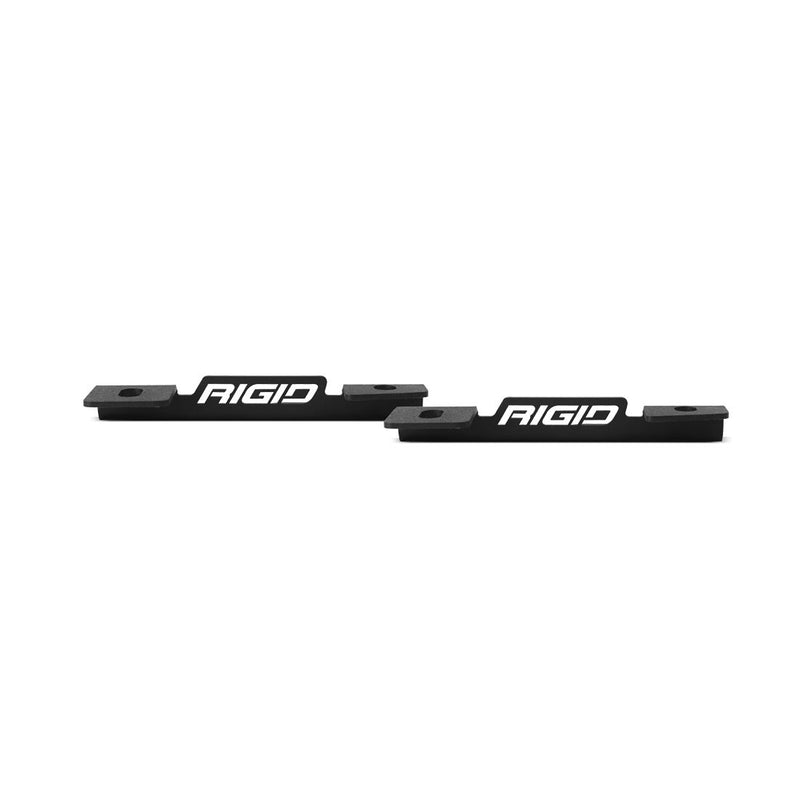 Rigid Dual Pod A-Pillar Mount Kit on a studio background: two flat black bracket plates with Rigid logo cutouts on white