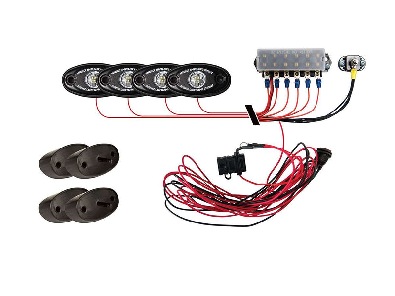 Rigid A-Series Rock Light Kit 4 contents: four lights, control module and wiring harness on white