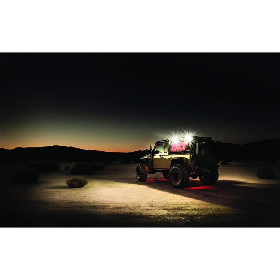 Scene Lights by Rigid: A lifted Jeep pickup in the desert at dusk throws bright work light across the ground.