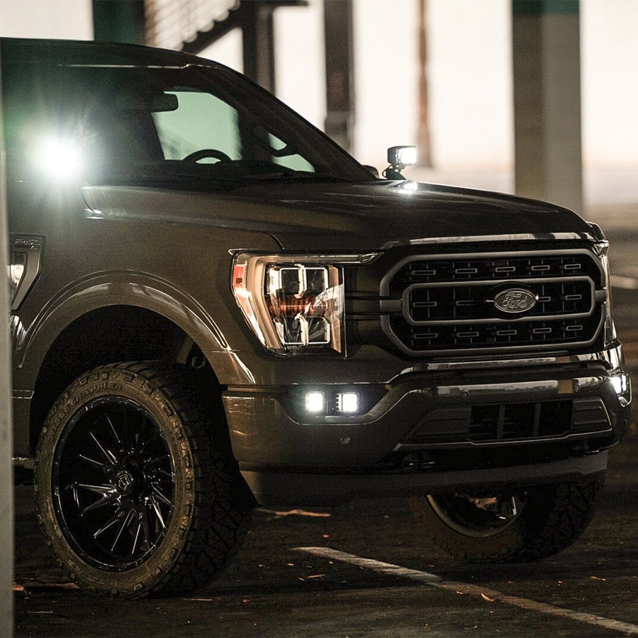 Vehicle-Specific Mounts & Brackets by Rigid: A dark Ford F-150 at night with a white pod lit on its A-pillar.