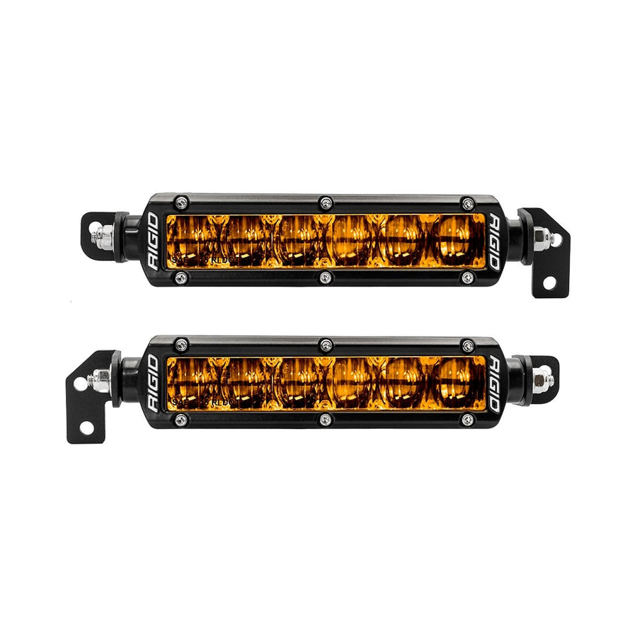 Vehicle-Specific Light Kits by Rigid: Two short black LED light bars with selective yellow lenses and mounting brackets shown on white.