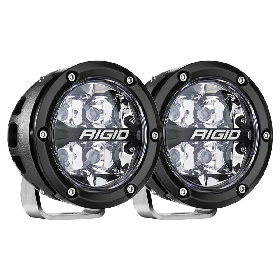 Vehicle-Specific Light Kits by Rigid: A pair of black round LED pods with spot optics on stainless brackets on a white background.